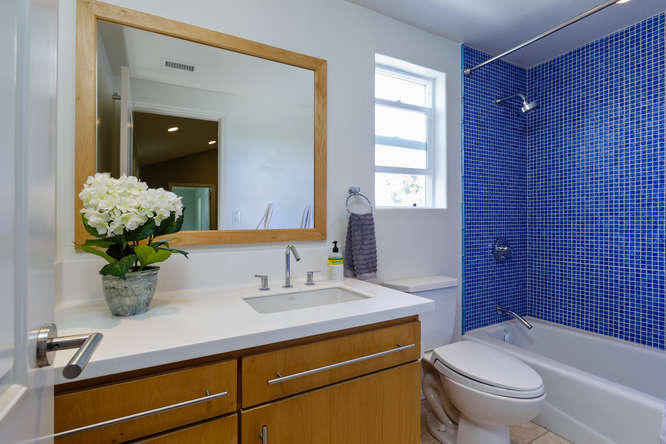1330 Beachmont Street Ventura, CA 93001 - Photo 25 of 35 a bathroom with a granite countertop sink a toilet and shower