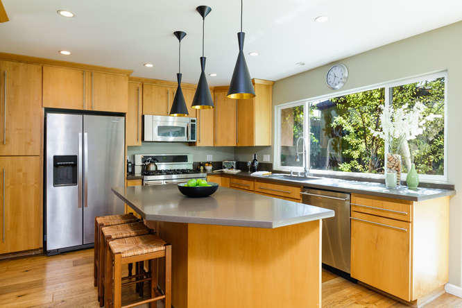 1330 Beachmont Street Ventura, CA 93001 - Photo 9 of 35 a kitchen with stainless steel appliances wooden floor sink and wooden cabinets