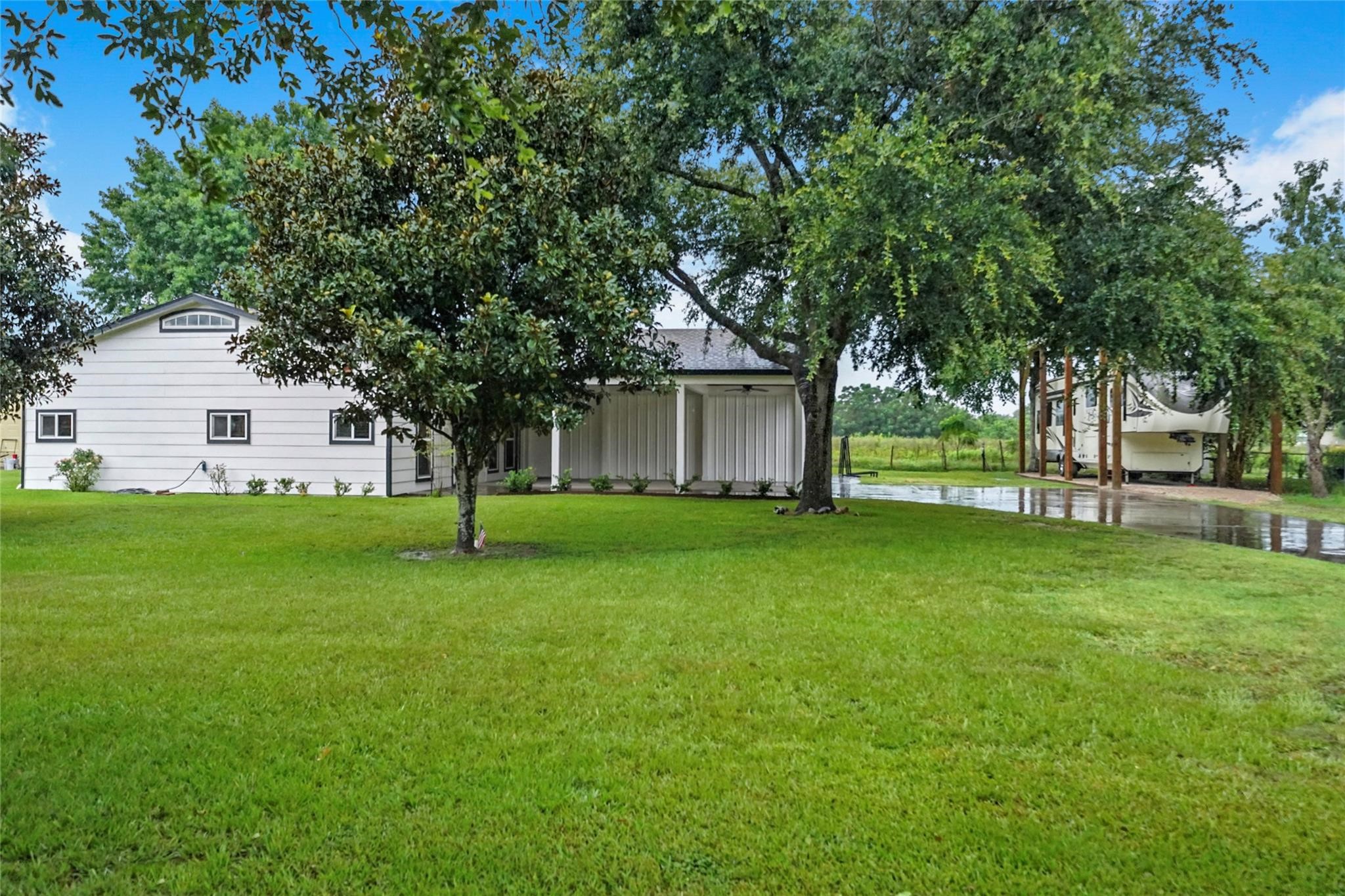 30720 Waller Spring Creek Road Waller, TX 77484 - Photo 19 of 22 Another look from the home showcasing the covered RV parking with plenty of space and functionality.