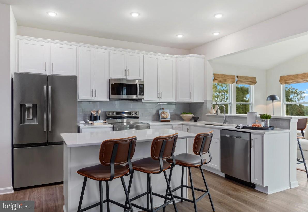 29 Peters Avenue Ranson, WV 25438 - Photo 6 of 23 Kitchen island and stainless steel appliances