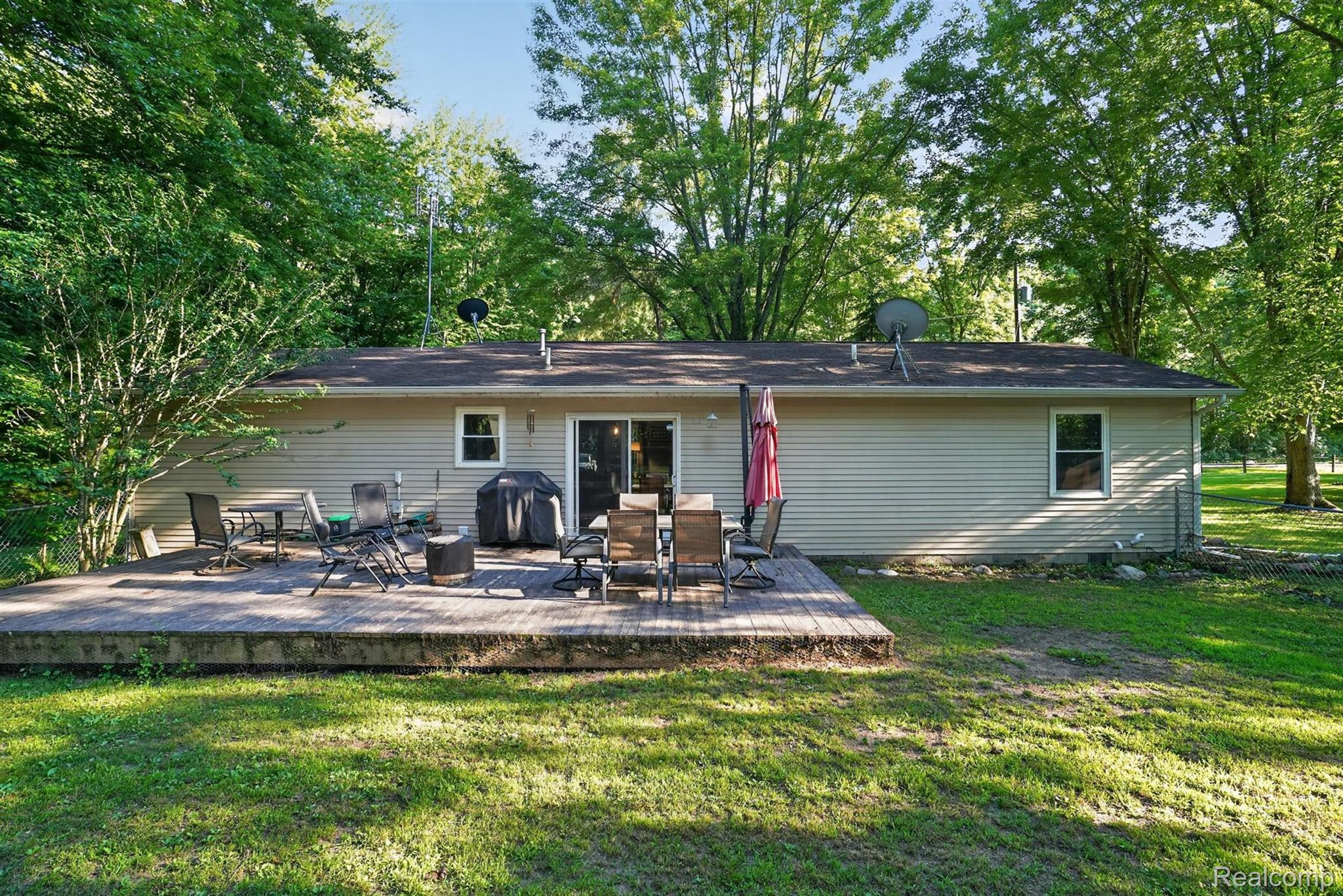 8696 West Sargent Road Fowlerville, MI 48836 - Photo 30 of 36 Spacious rear deck with direct access to interior via sliding glass doors