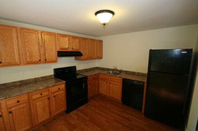7 Padanaram Road, Unit 147 Danbury, CT 06811 - Photo 1 of 1 a kitchen with stainless steel appliances granite countertop a refrigerator a sink dishwasher and wooden cabinets with wooden floor