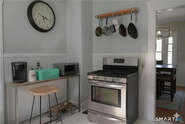 a kitchen with white cabinets and sink
