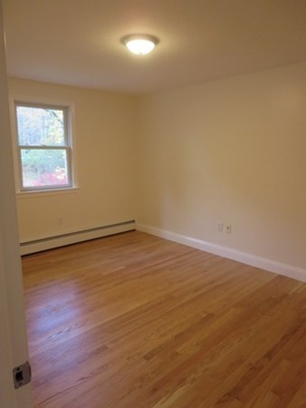 112 West Groton Road Shirley, MA 01464 - Photo 12 of 29 an empty room with wooden floor and windows