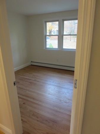 112 West Groton Road Shirley, MA 01464 - Photo 15 of 29 an empty room with wooden floor and windows