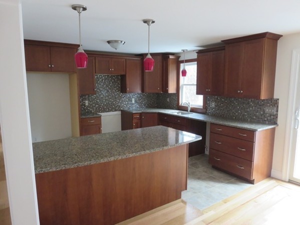 112 West Groton Road Shirley, MA 01464 - Photo 4 of 29 a kitchen with kitchen island granite countertop wooden cabinets and a refrigerator