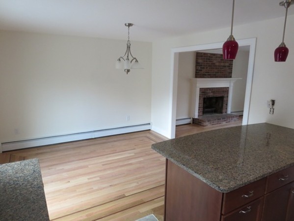112 West Groton Road Shirley, MA 01464 - Photo 6 of 29 a kitchen with a sink granite counter tops and a fireplace