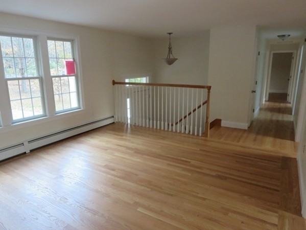 112 West Groton Road Shirley, MA 01464 - Photo 8 of 29 an empty room with wooden floor and windows
