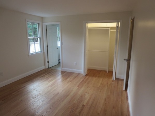 112 West Groton Road Shirley, MA 01464 - Photo 10 of 29 an empty room with wooden floor and windows