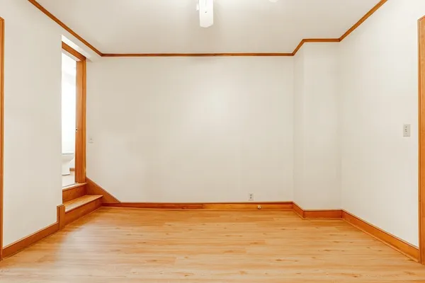 a view of a room with wooden floor