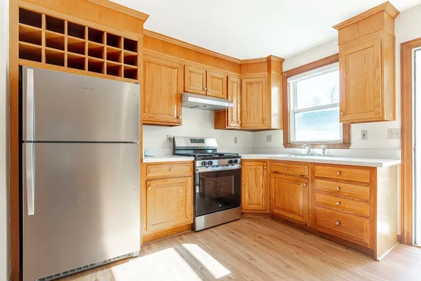 a kitchen with stainless steel appliances granite countertop a refrigerator a stove a sink and a microwave