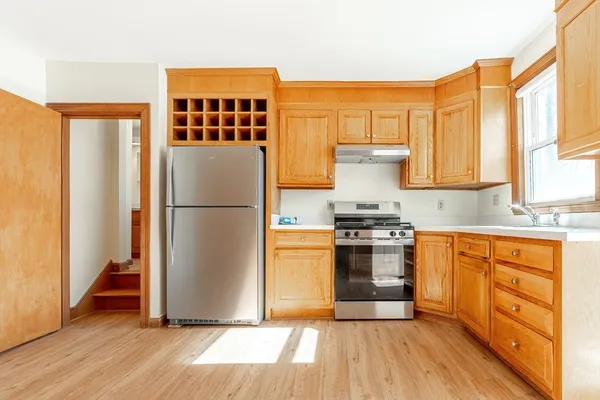 a kitchen with stainless steel appliances granite countertop a refrigerator and a stove top oven