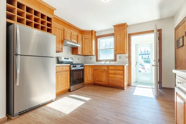 a kitchen with stainless steel appliances a refrigerator and a stove