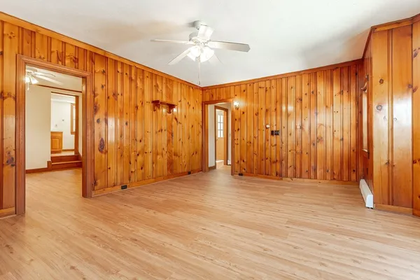 a view of an empty room with wooden floor