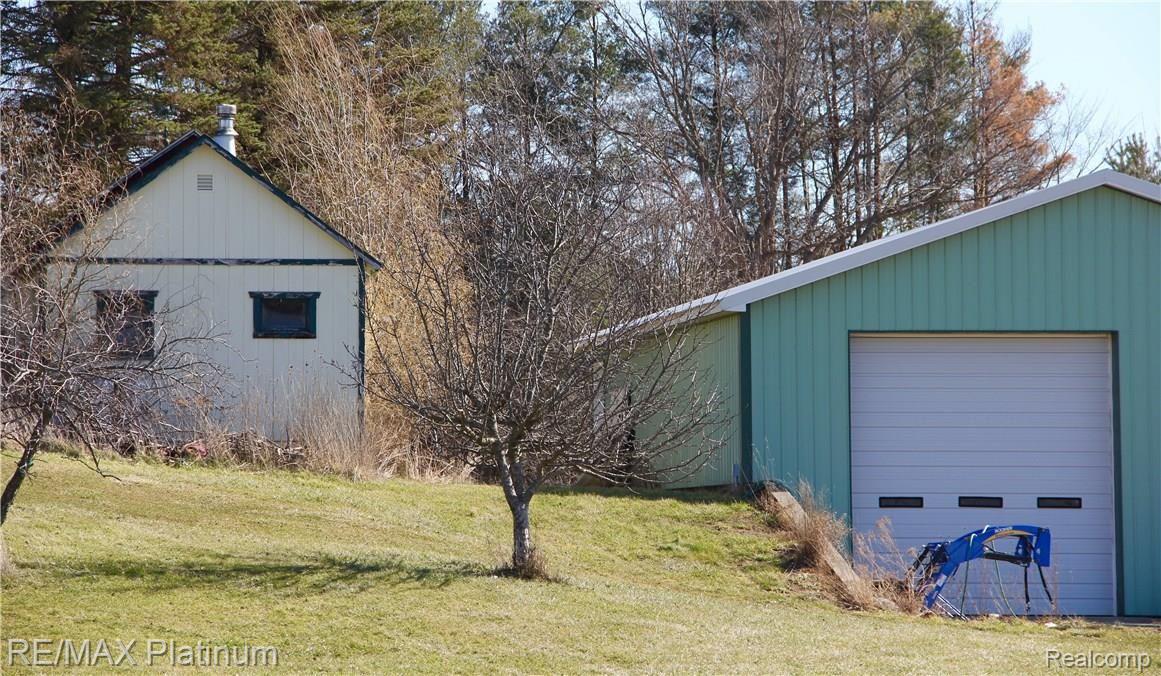 2255 Brewer Road Howell, MI 48855 - Photo 25 of 28 Back View of Metal Pole Barn and Garage/Storage Building