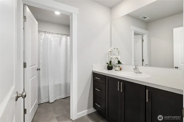 a bathroom with a double vanity sink and mirror