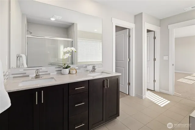 a bathroom with a double vanity sink a and mirror
