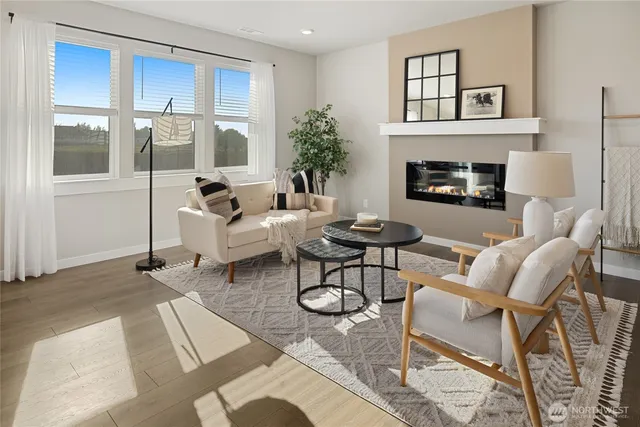 a living room with furniture a fireplace and a window