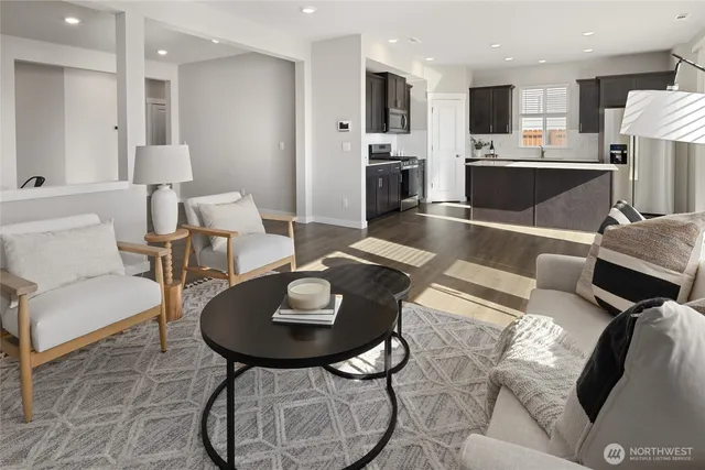 a living room with furniture kitchen and a table