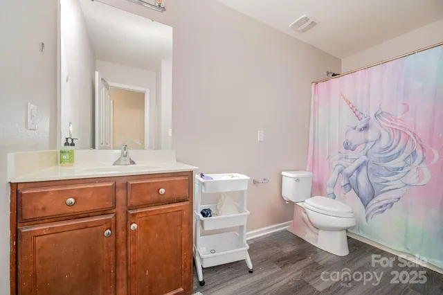 a bathroom with a sink toilet and a mirror