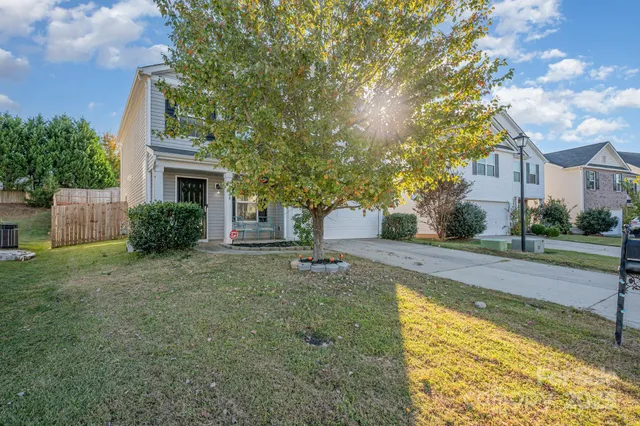 a front view of a house with a yard garage and outdoor seating