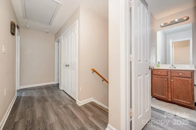 a view of a hallway with wooden floor