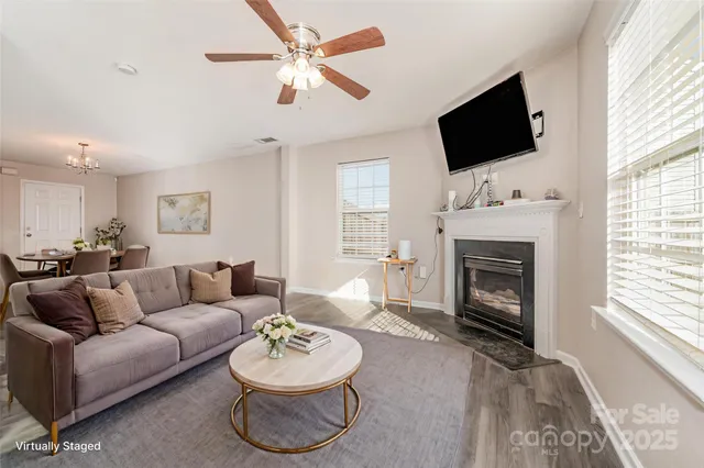 a living room with furniture a fireplace and a flat screen tv