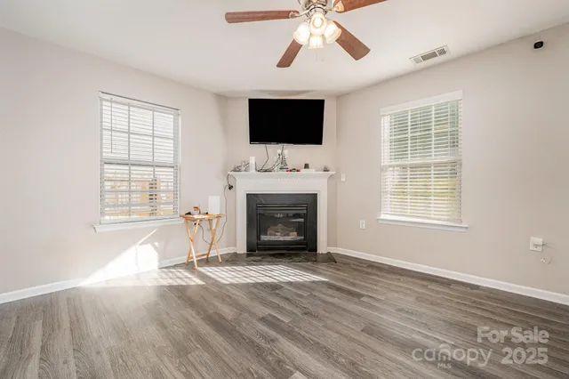 a living room with fireplace furniture flat screen tv and a fireplace