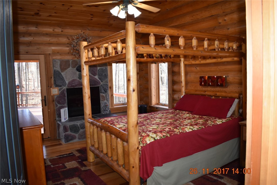 9736 Liberty Road Twinsburg, OH 44087 - Photo 16 of 31 Master bedrm, with bed, wood burning fireplace with gas logs, large walk in closet, full bath rm with jetted tub, double bowl sinks, glass enclosed shower, skylights