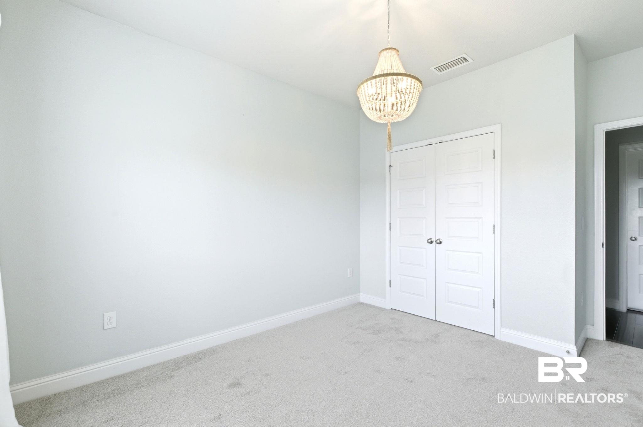 31187 Spoonbill Road Daphne, AL 36527 - Photo 84 of 85 Neutral painted walls with white baseboards and light-toned carpet flooring