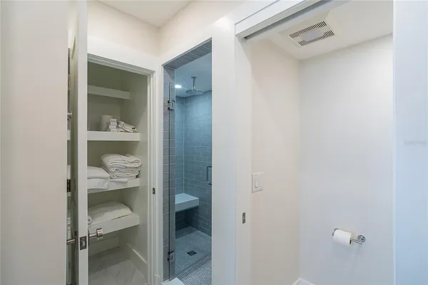 a bathroom with a glass shower door