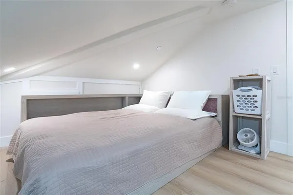 a bedroom with a bed and a dresser