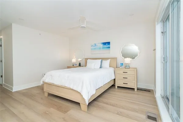 a bedroom with a large bed and a chandelier