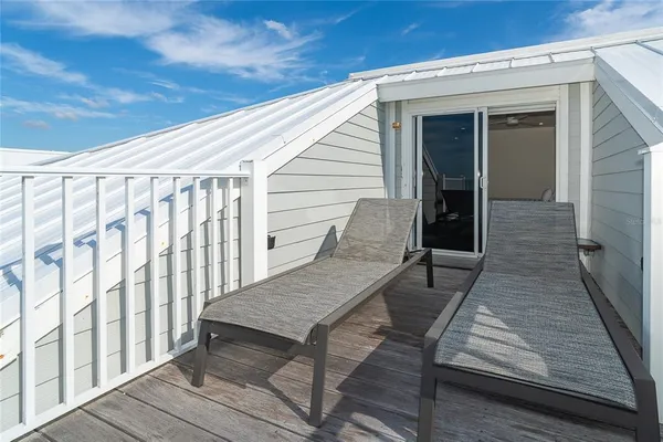 a view of balcony with wooden floor and seating space
