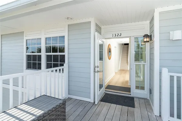 a view of a balcony with wooden floor and fence
