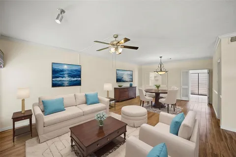 a living room with furniture fireplace and a chandelier