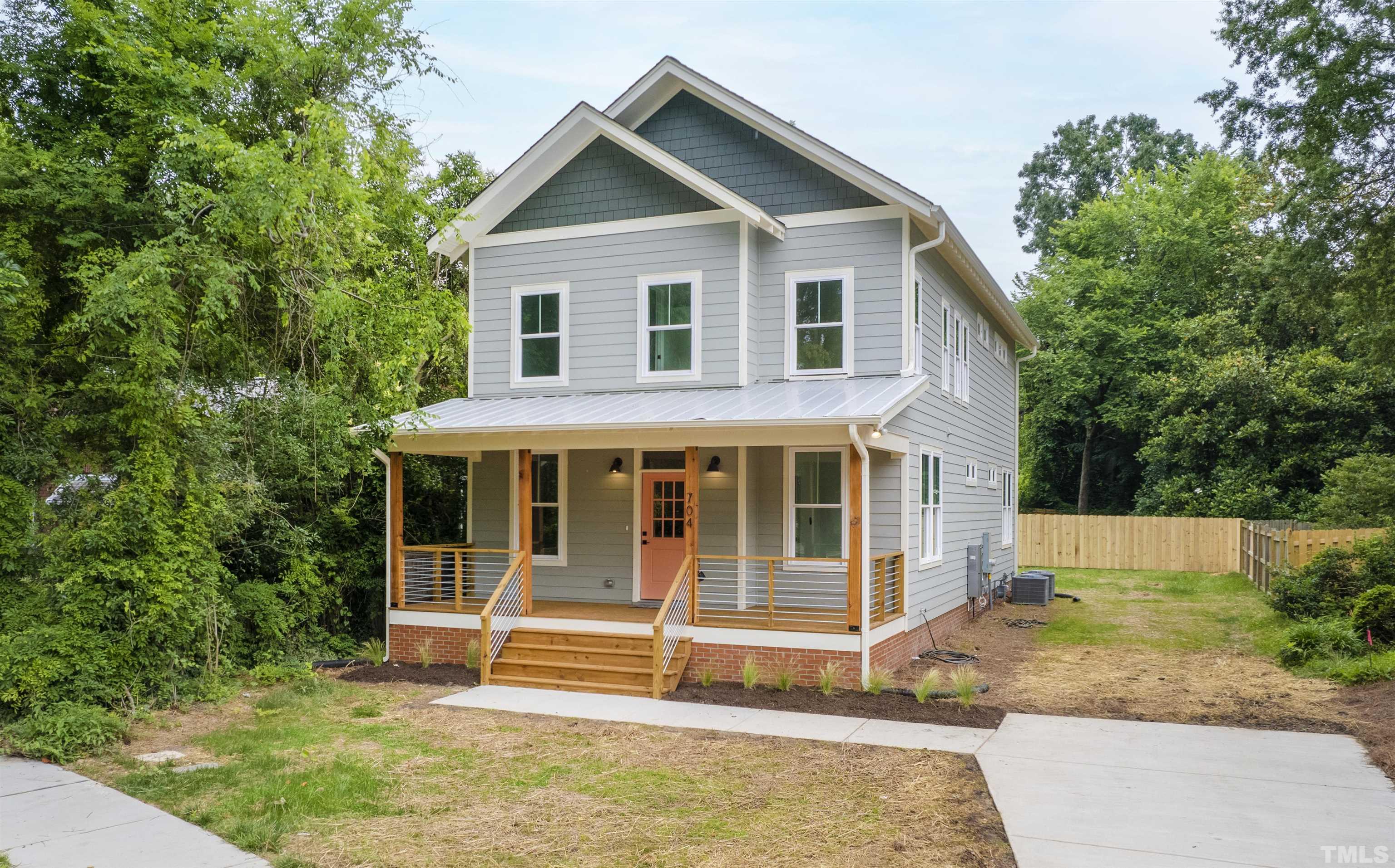 704 Colonial Street Durham, NC 27701 - Photo 1 of 42 a view of a house with a yard and sitting area