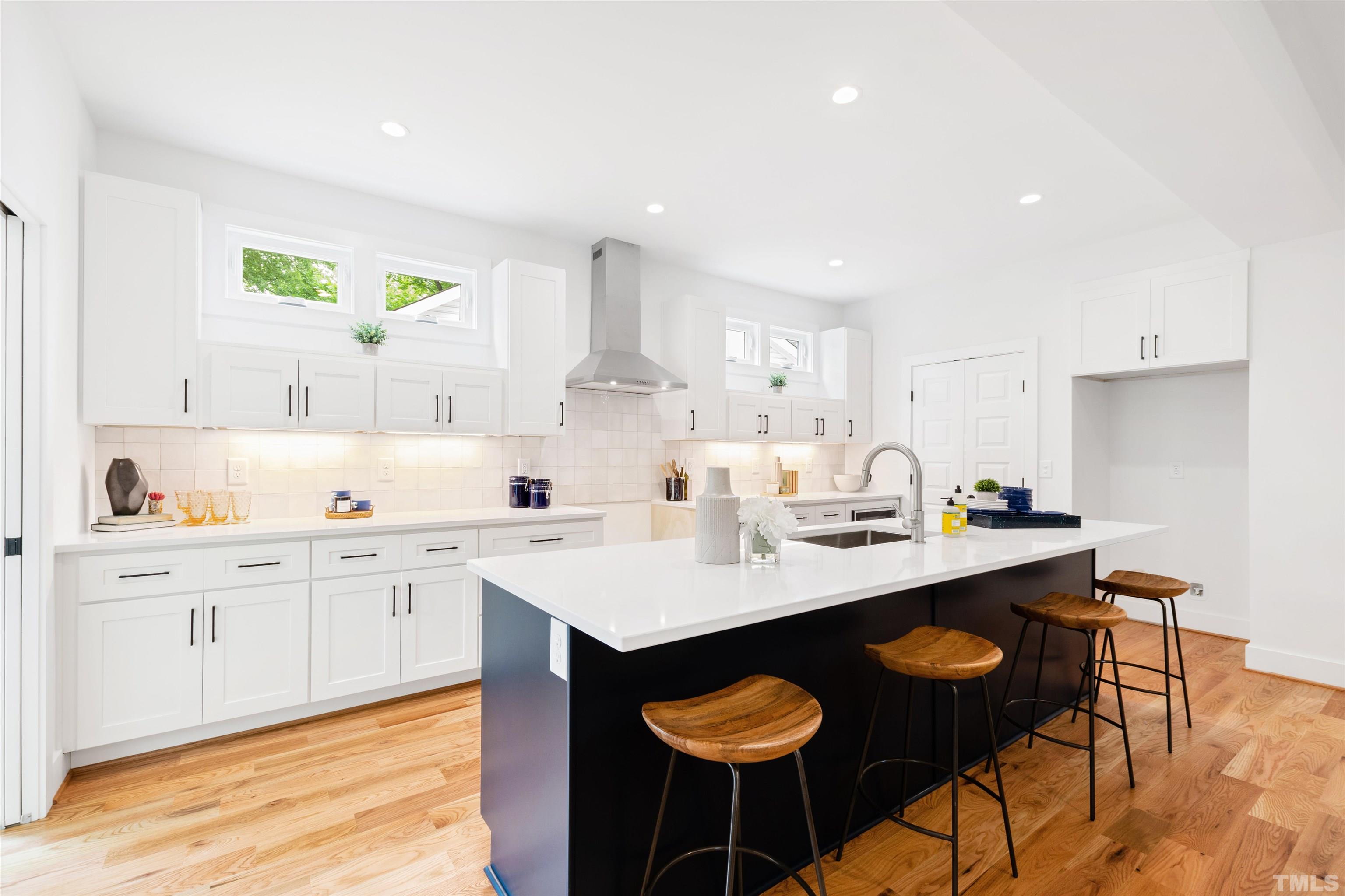 704 Colonial Street Durham, NC 27701 - Photo 16 of 42 a kitchen with stainless steel appliances granite countertop a sink and a white cabinets