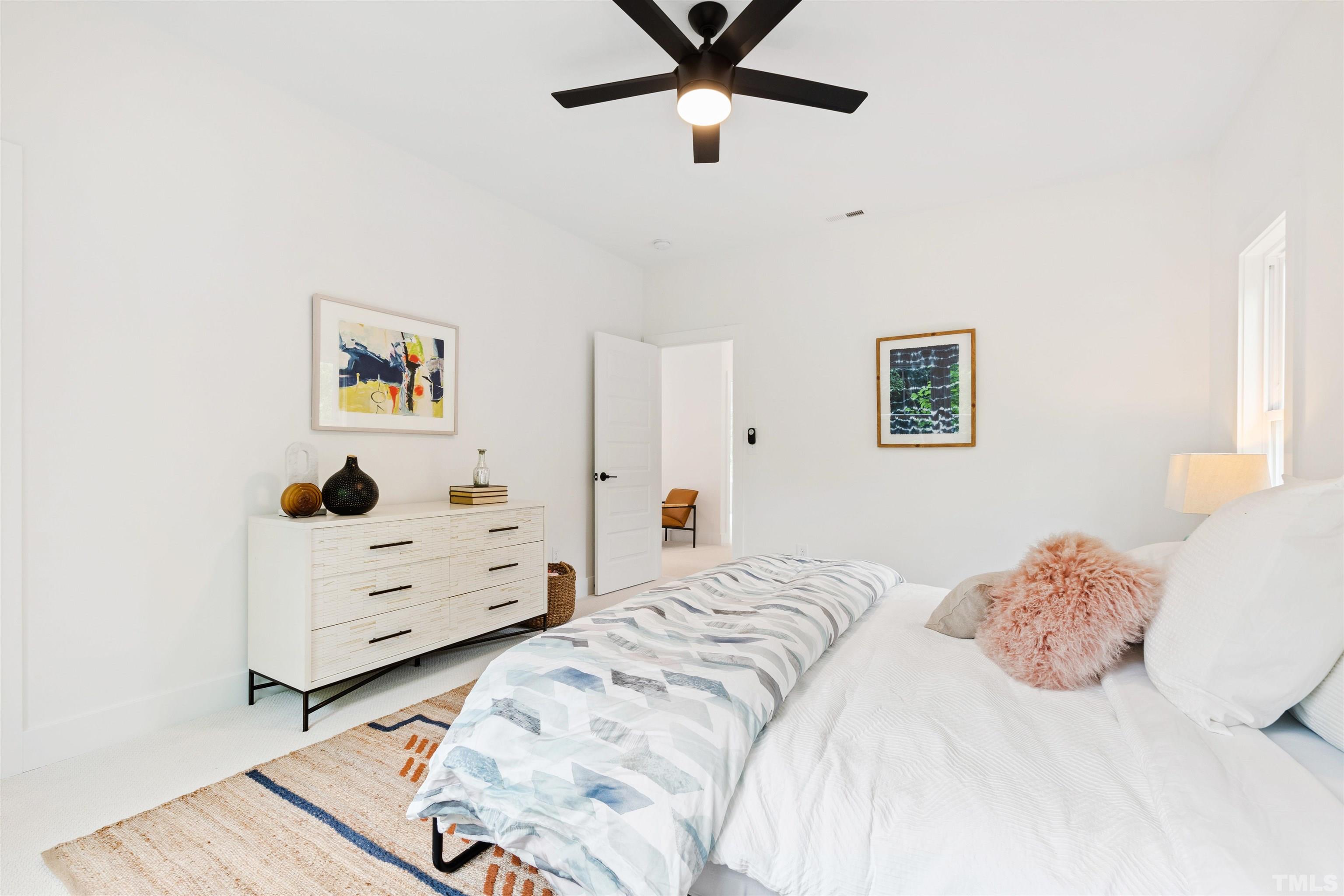 704 Colonial Street Durham, NC 27701 - Photo 25 of 42 a bedroom with a bed and a dresser