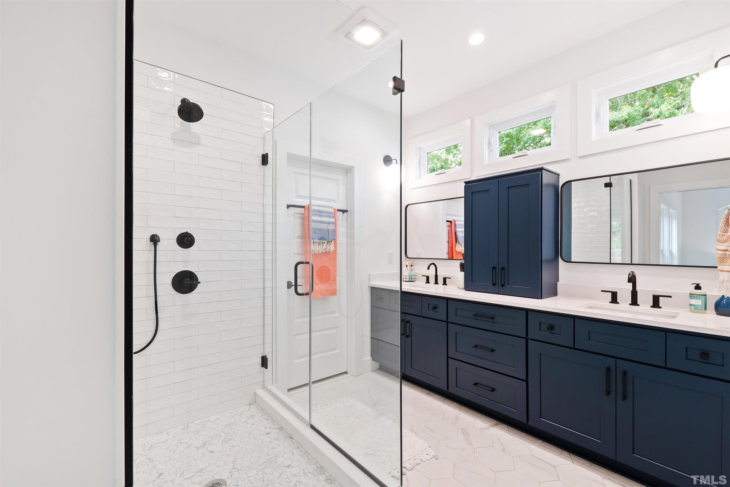 704 Colonial Street Durham, NC 27701 - Photo 26 of 42 a bathroom with a double vanity sink mirror and double