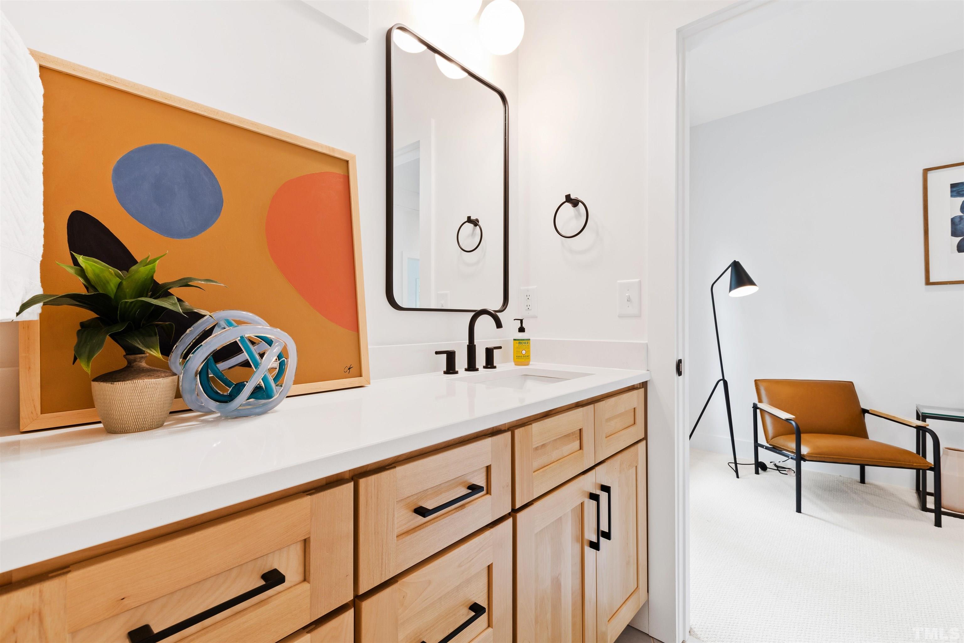 704 Colonial Street Durham, NC 27701 - Photo 30 of 42 a bathroom with a sink and a mirror