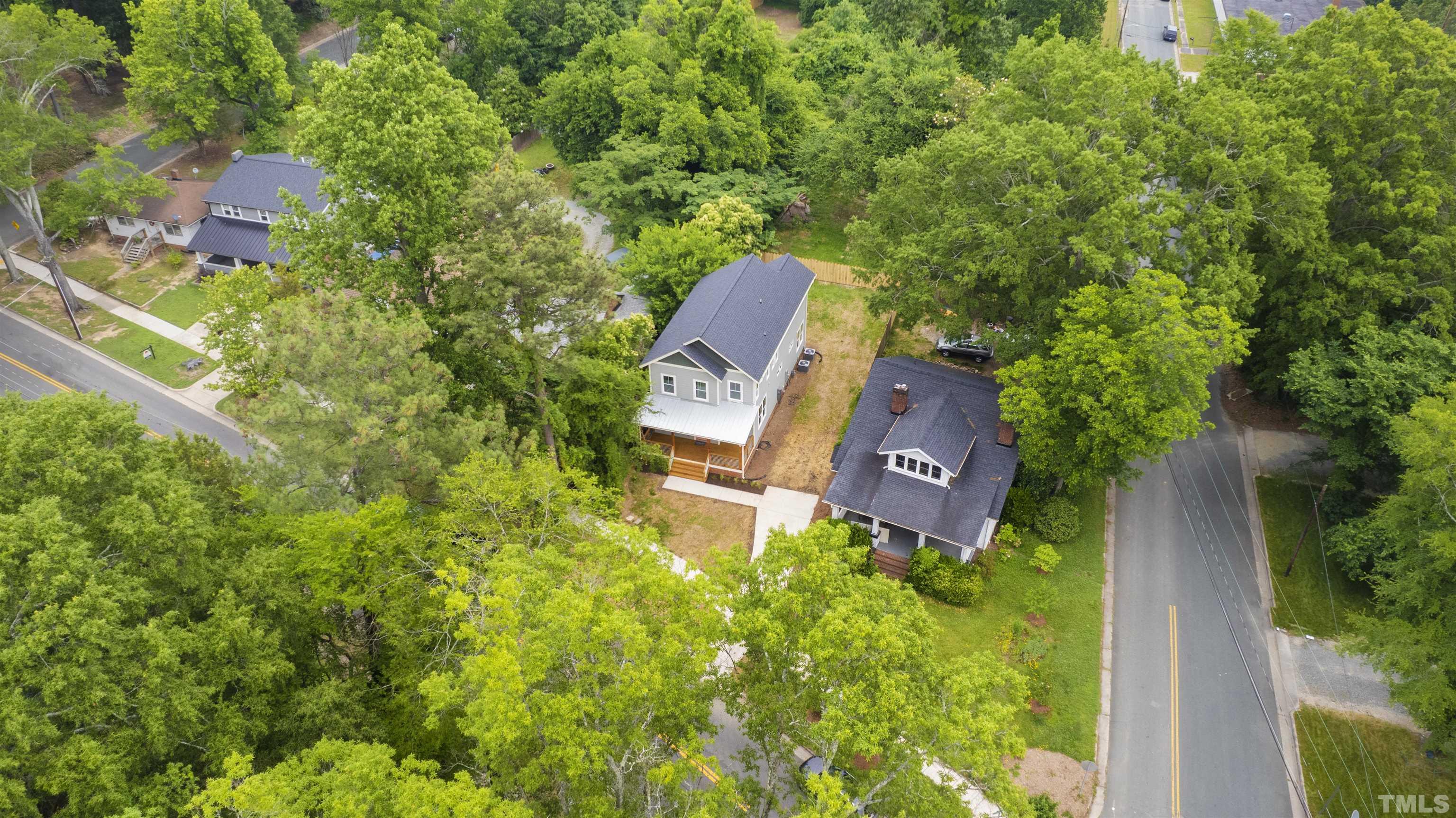 704 Colonial Street Durham, NC 27701 - Photo 42 of 42 an aerial view of a house with a yard and trees all around