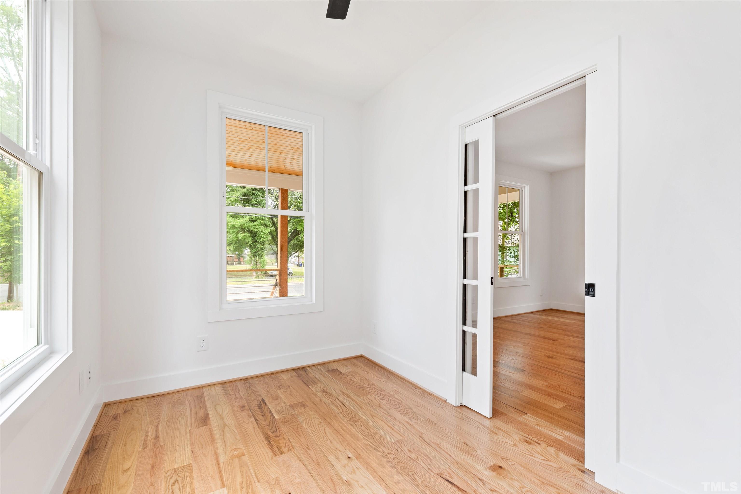 704 Colonial Street Durham, NC 27701 - Photo 9 of 42 a view of an empty room with wooden floor and a window