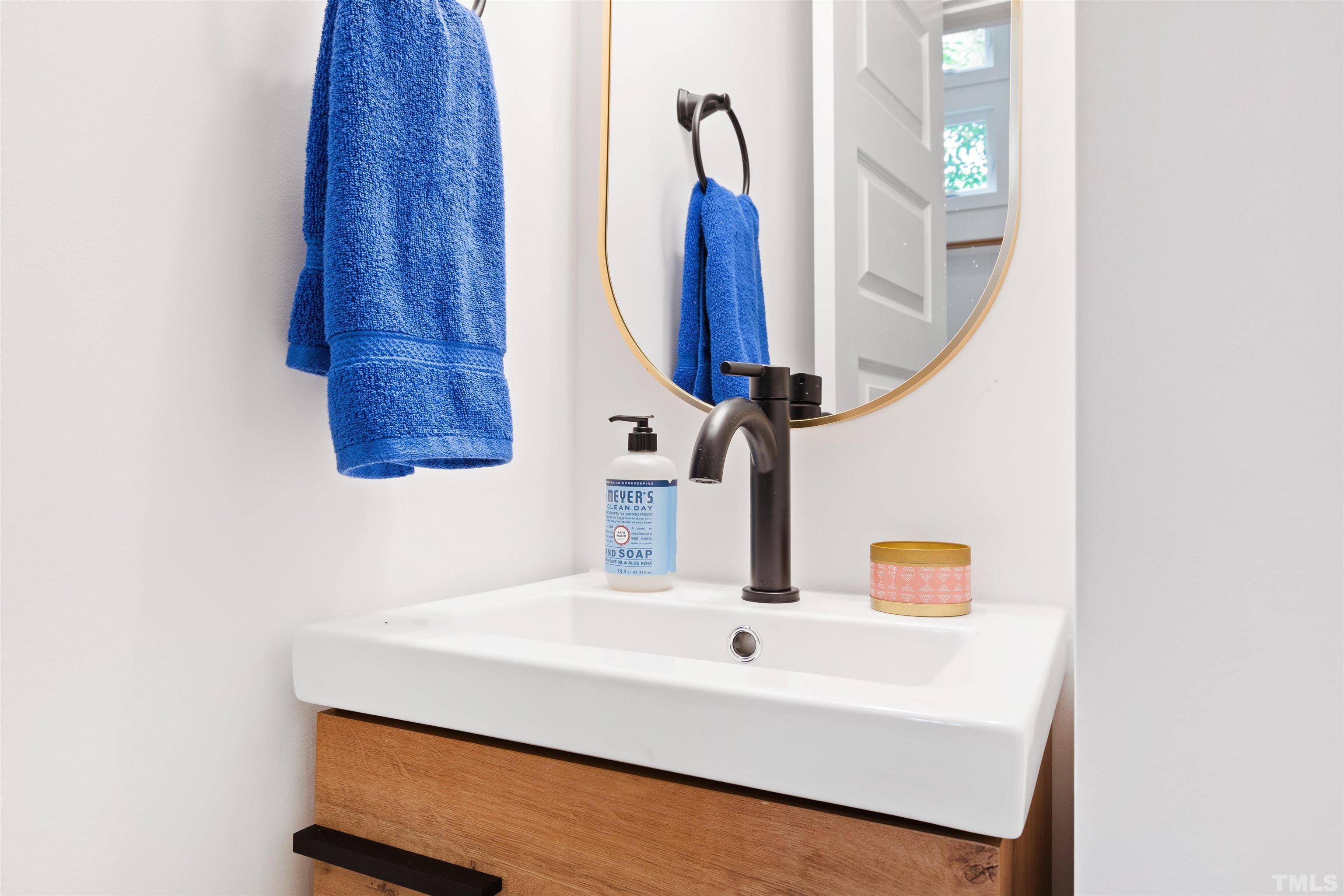 704 Colonial Street Durham, NC 27701 - Photo 10 of 42 a bathroom with a sink and a mirror