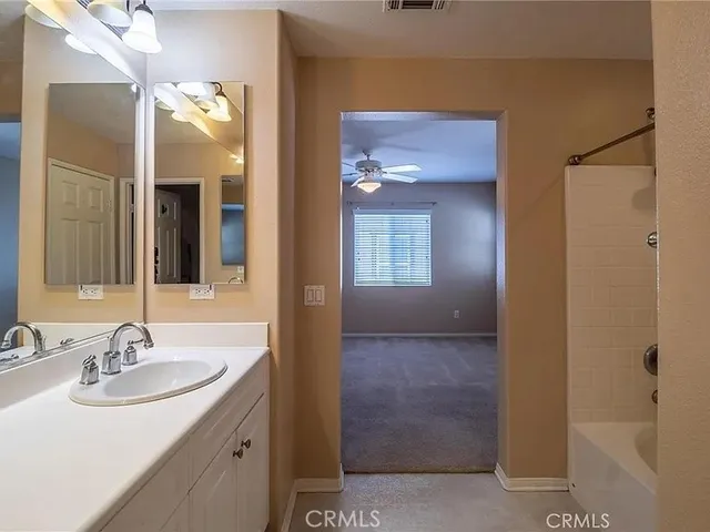 an empty room with closet and windows