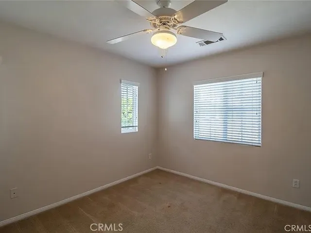 a view of a livingroom with furniture and floor to ceiling window