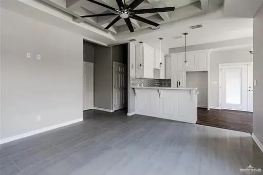 a view of a kitchen with a sink and dishwasher refrigerator a microwave