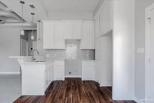 a kitchen with a sink and cabinets