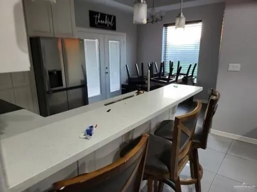 a kitchen with a table chairs and refrigerator