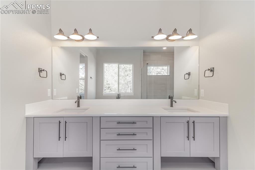 10675 Hardy Road Colorado Springs, CO 80908 - Photo 16 of 45 a bathroom with a sink and a mirror